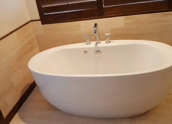 Finished bathroom vanity with mirrors and tile floor