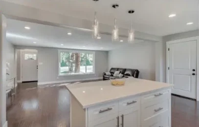 Kitchen island with quartz counters and shaker cabinets