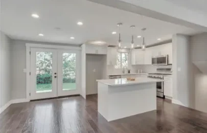 Remodeled kitchen with island and french doors to the yard