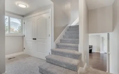 New entry with carpeted staircase and fresh trim